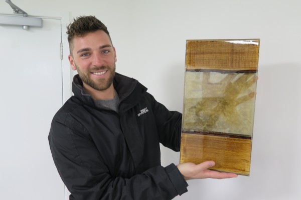 Sam Oliver holds up a test section of a ‘River Table’ made using ENTROPY RESINS CCR Clear Casting Epoxy