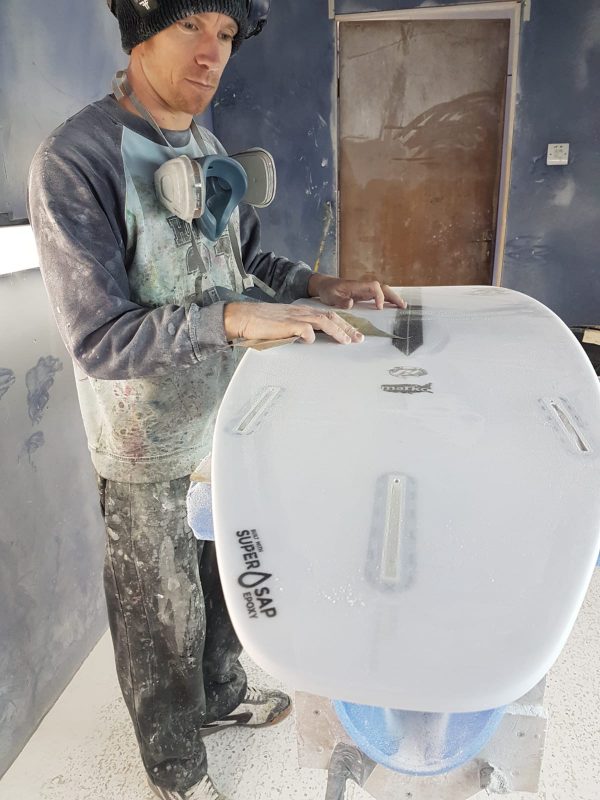 Luke Young at work on a board made with bio-based epoxy resin.