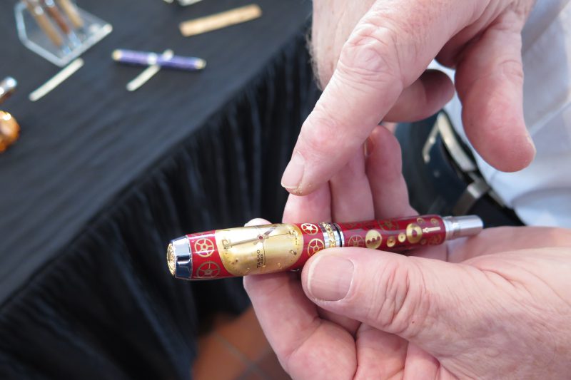 a pen with watches laid in - made with epoxy resin