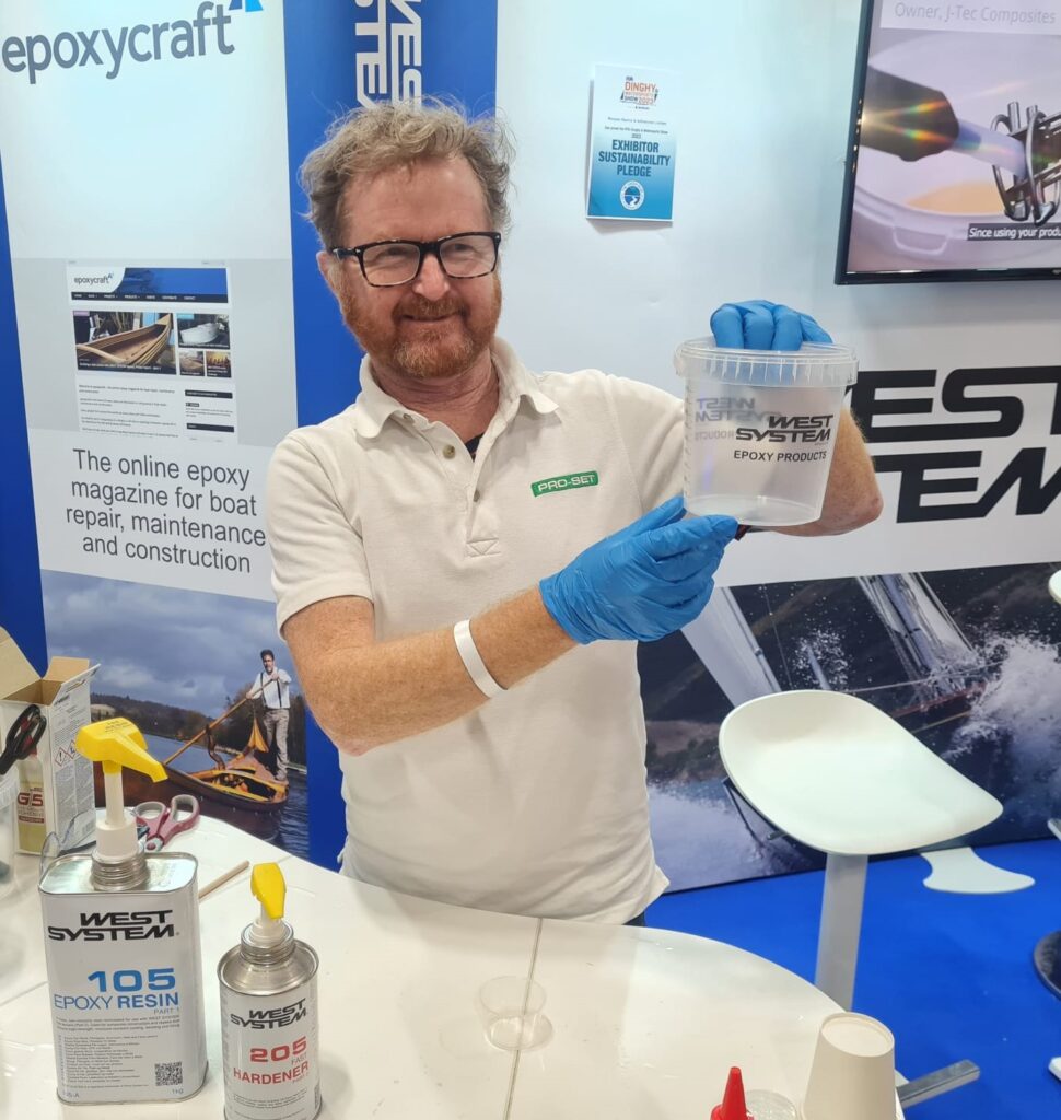 Sales director from Wessex resins and adhesives holding  demonstration at the rya dinghy show