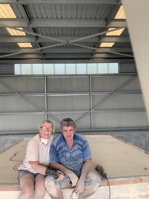 Glenn and Deb, covered in dust from working on their boat 