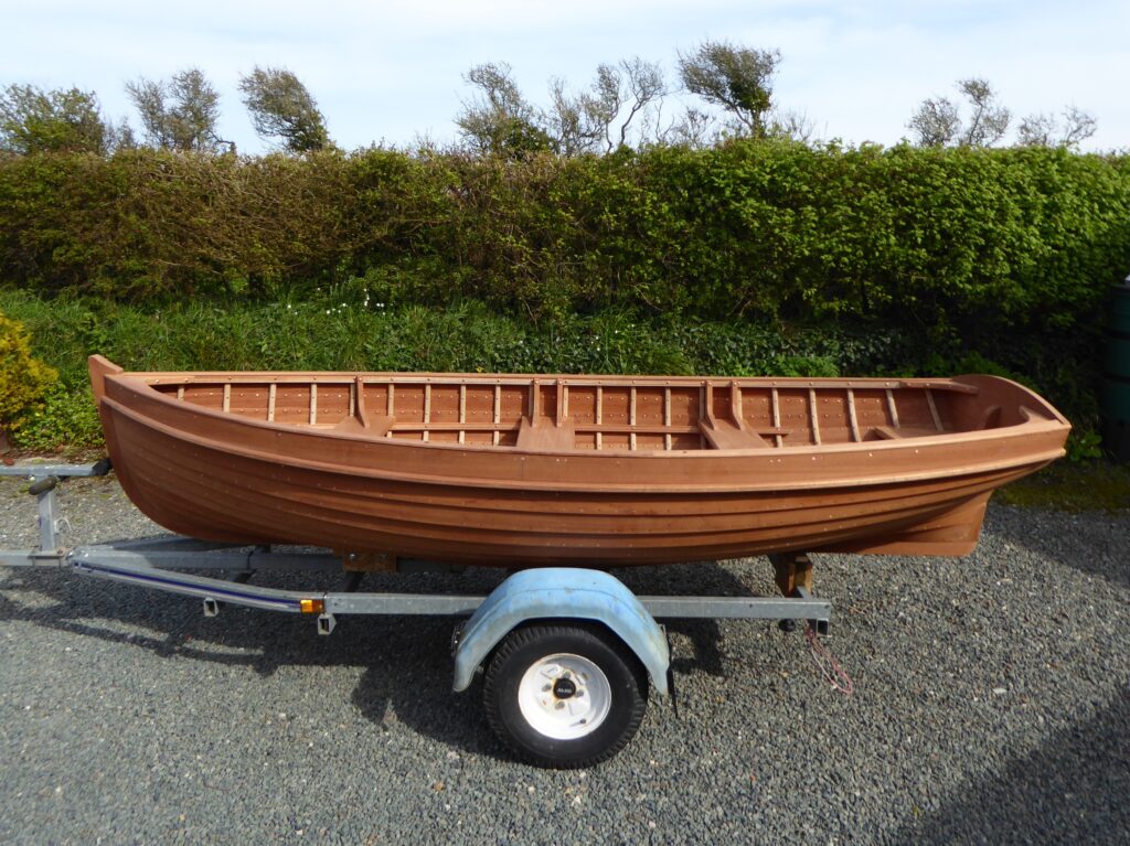 A boat made at the boat building academy in lyme regis incorporating west system epoxy into the build, sat on the trailor