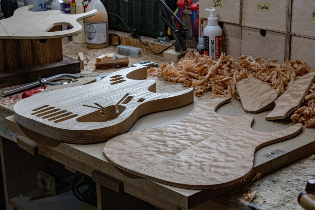 Wooden parts of guitars cut out and ready to be assembled. 