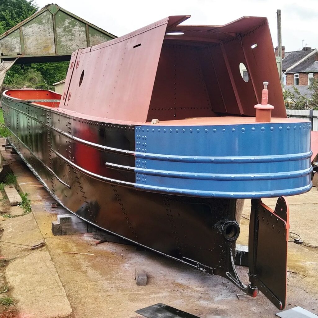 the metal frame of the narrow boat in the boatyard.